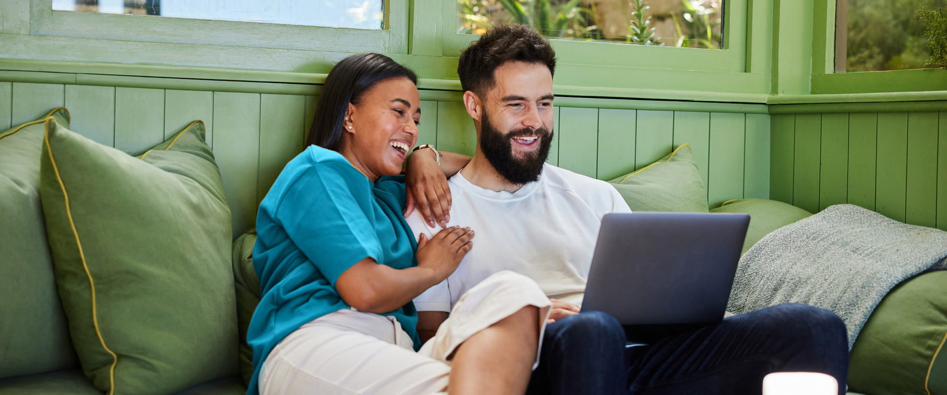 Couple snuggles up to enjoy online streaming over fiber internet, the MVP of internet delivery methods 