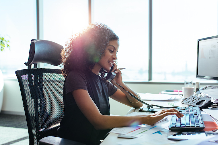 Busy young business person on the phone using fiber internet and voice